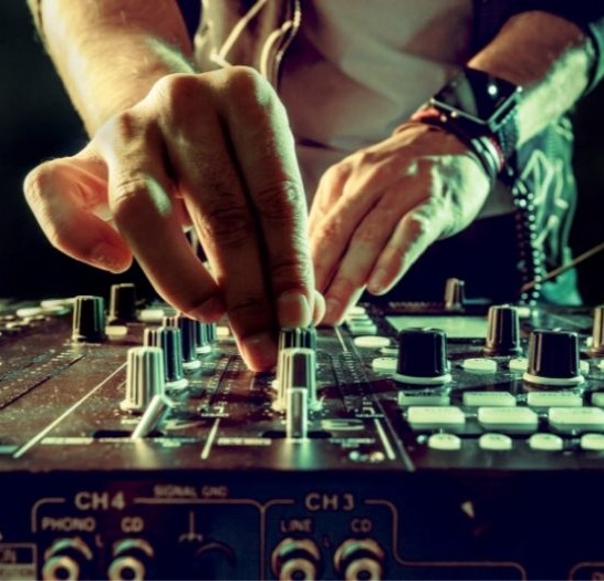 close up of a DJ's hands using a mixer